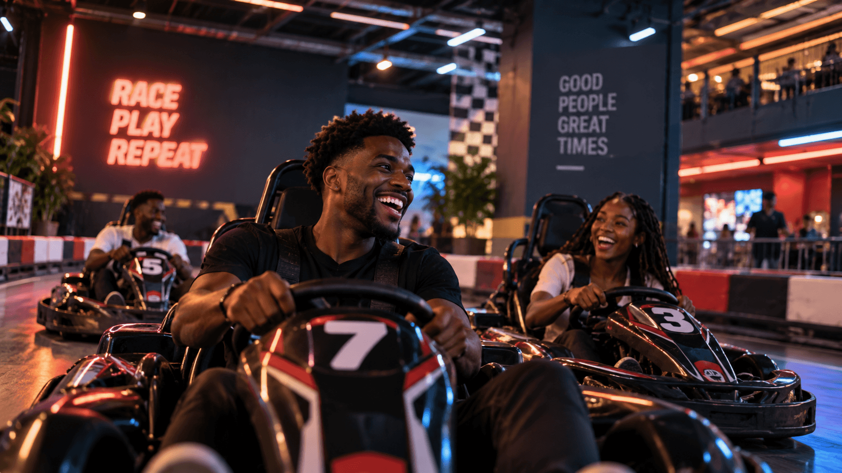 Friends laughing in go-karts at an indoor track